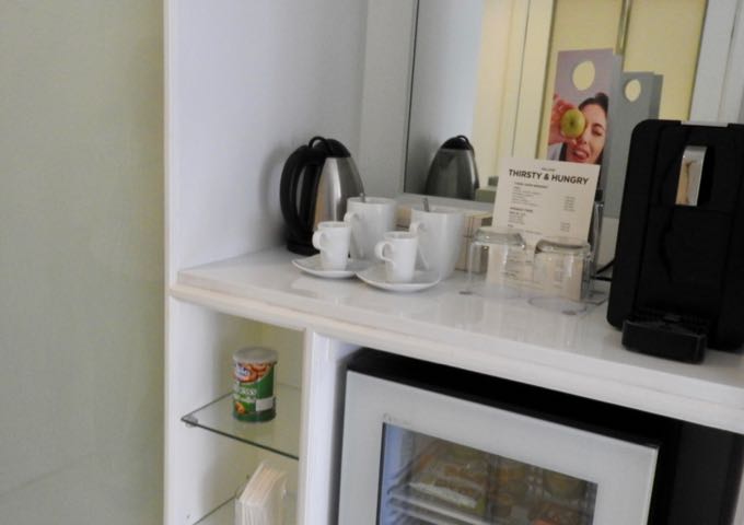The room has a mini-bar, hot water kettle, and coffee machine.