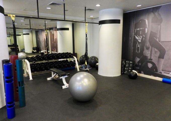 The adjoining room has weights and medicine balls.