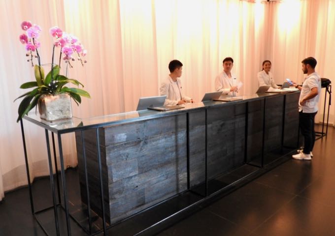 The lobby and reception have a modern, minimalist vibe.