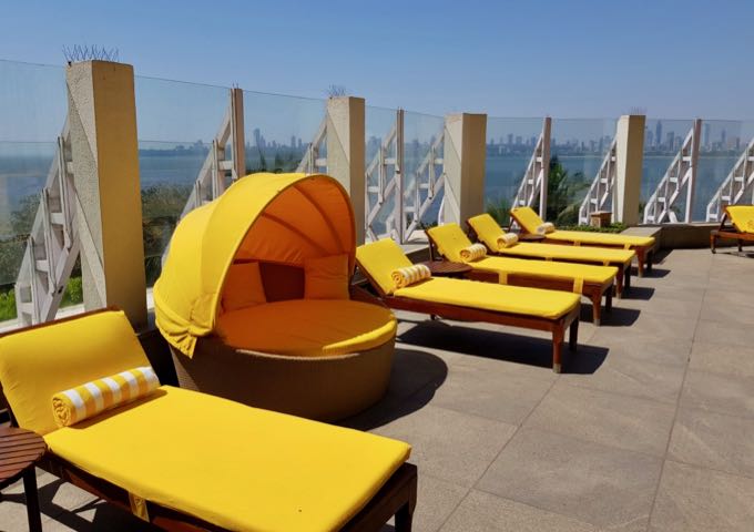 Colorful sunbeds on the pool deck of The Oberoi.