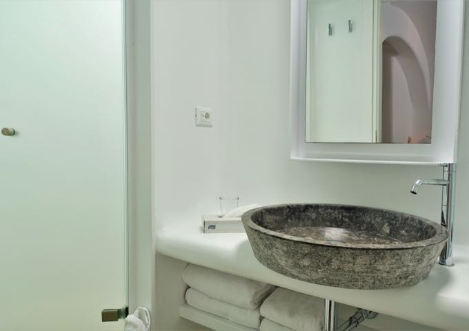 The bathroom has a stone basin.