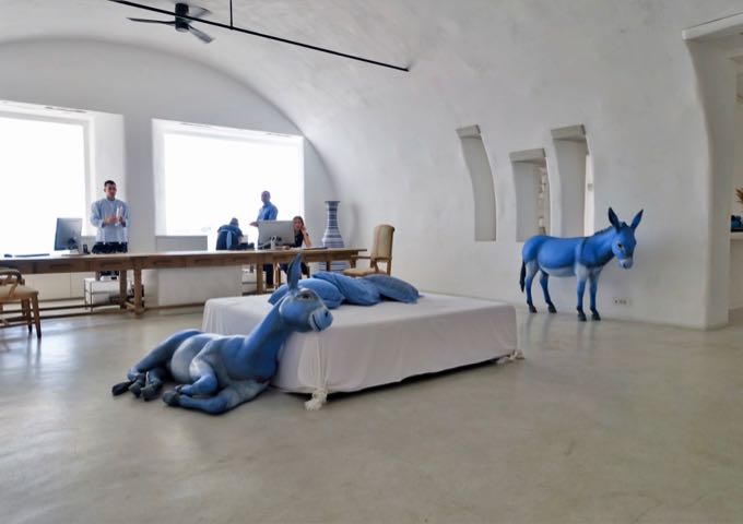 The 24/7-staffed reception features blue donkey statues.