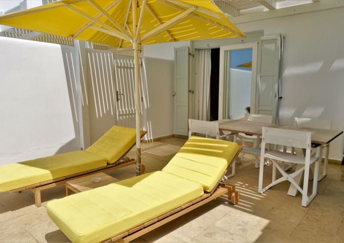 The terrace has 2 sunbeds and a dining table.