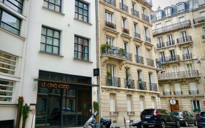 Exterior of a modern boutiqu hotel on a narrow street in Paris