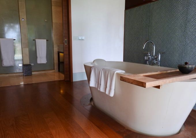 The standalone tub offers bay views.