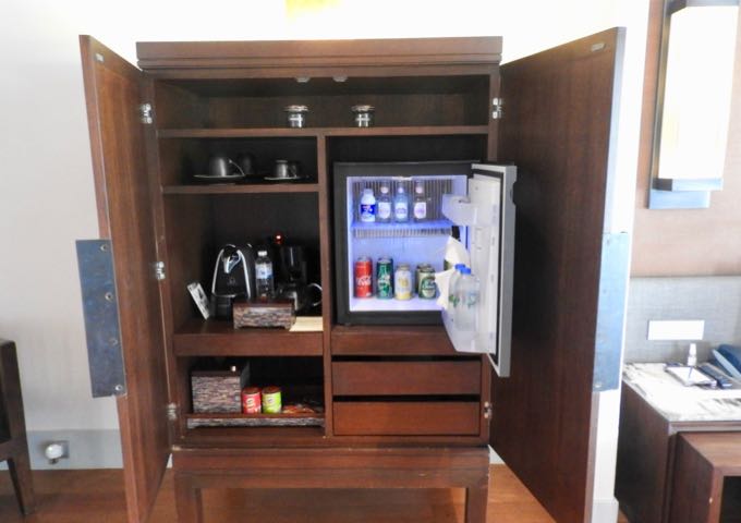 The mini bar has a small fridge and a coffee machine.