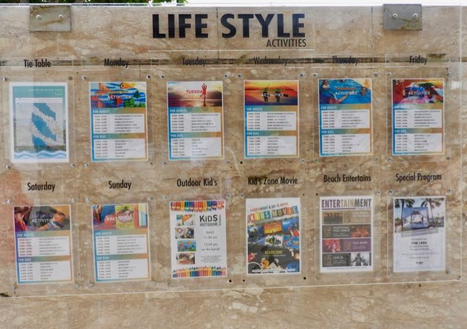 The notice board displays timings for activities and tides.
