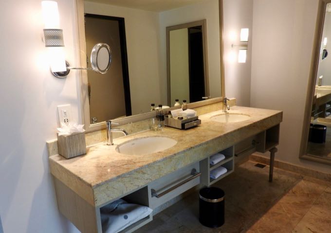 Suite bathrooms have dual vanities and rain showers.