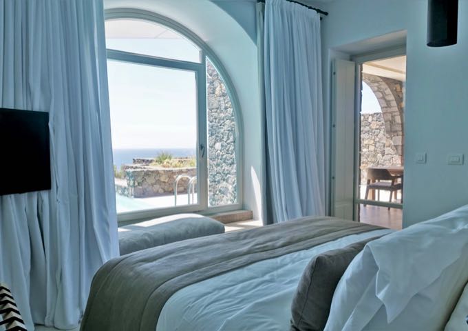 One of the bedroom overlooks the pool and sea.