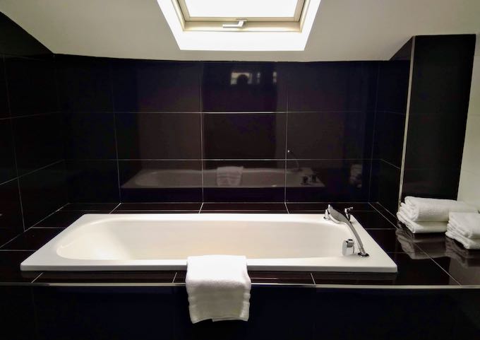 The Prestige Suite's bathtub is lit by a skylight.