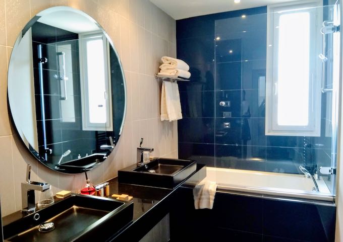 The Rotonde Suite bathroom has twin sinks and a bathtub.