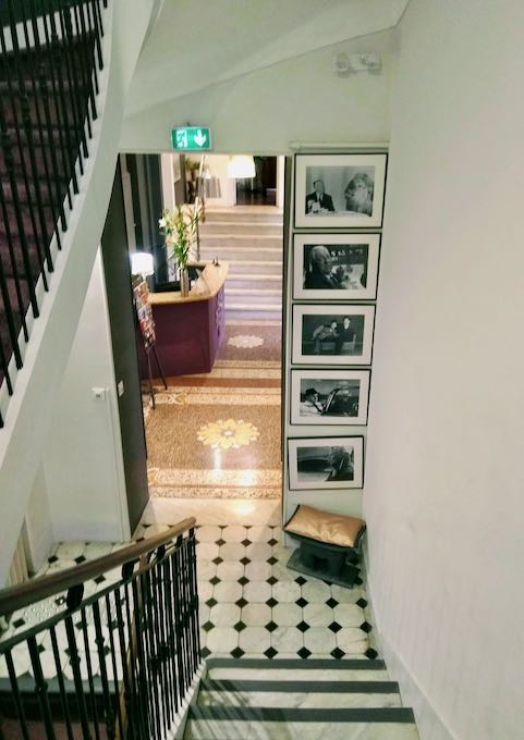 The sweeping staircase is decorated with film icon photos.