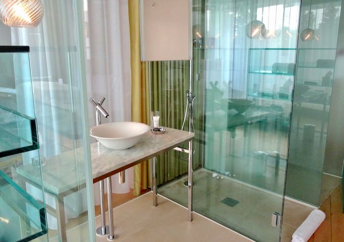 Glass bathrooms are a signature feature.