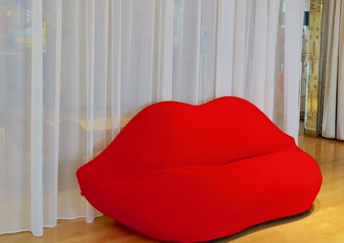 A bright red sofa welcomes guests.
