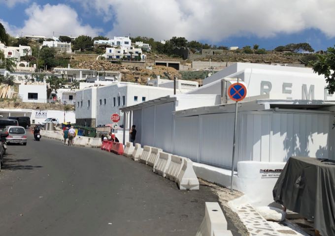 Street in Mykonos town, with a taxi stand in the corner