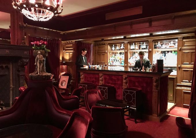 The red velvet second salon has the main bar.