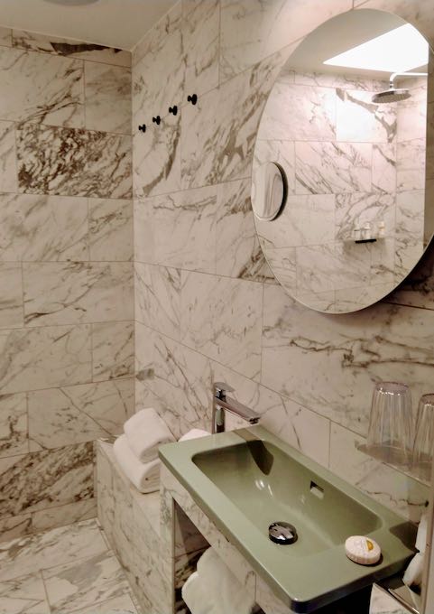 Bathrooms have an elegant marble effect.