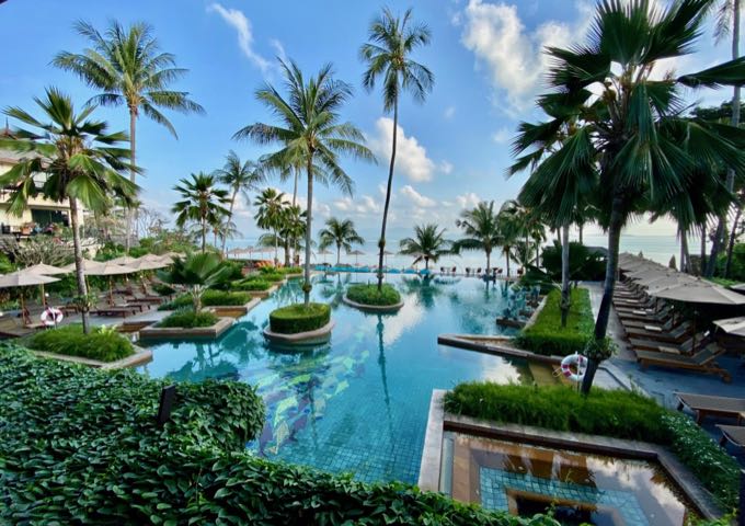 elegant swimming pool with garden-like islands, overlooking the sea
