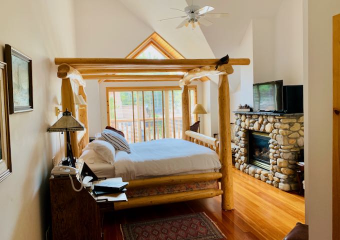 The Edith Room has a canopy bed and river rock fireplace.