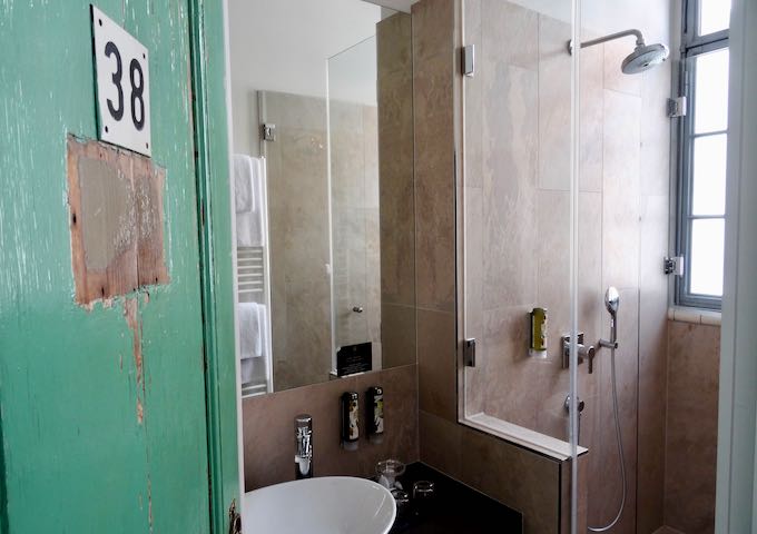 The modern bathrooms feature the bathhouse's original bathroom doors.