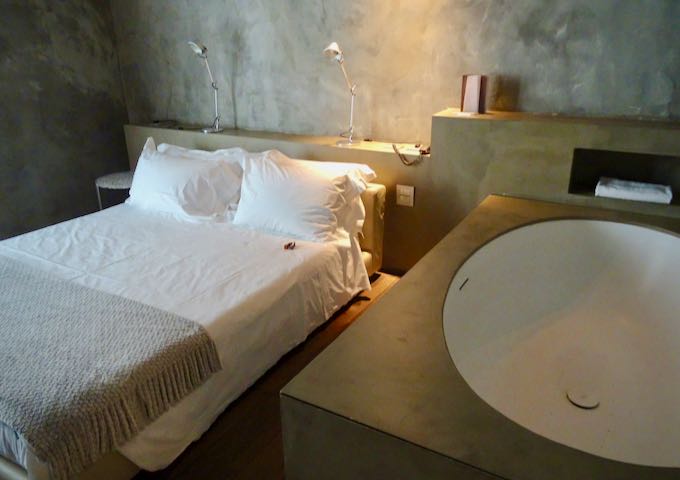 Minimalist hotel room with double bed and in-room bathtub