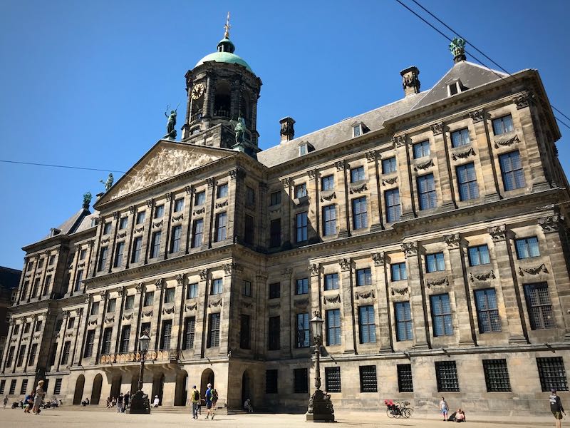 Ornate exterior of Amsterdam's Royal Palace on a sunny day