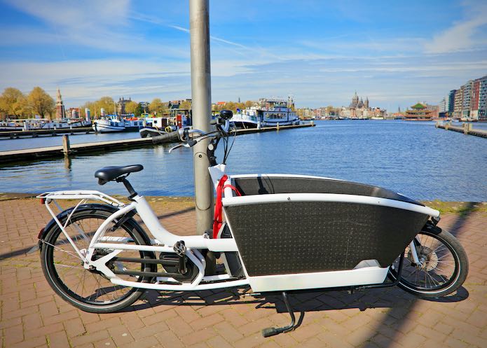Cargo bike parked near a canal in Amsterdam