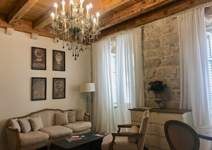 The first-floor suite has original wooden beams and stone wall.