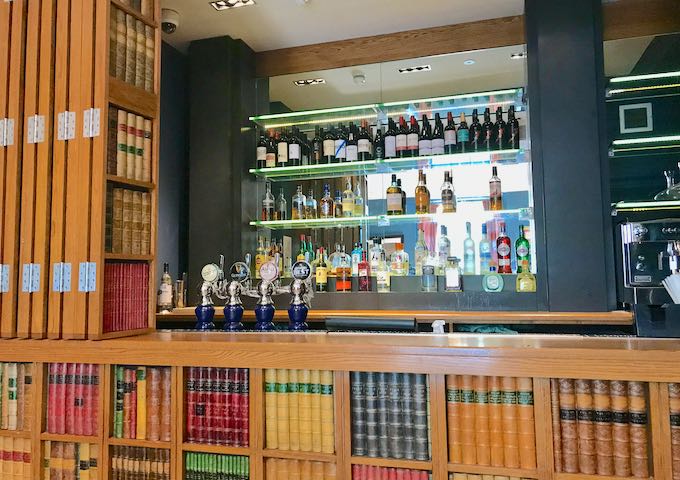 The bar is hidden behind a fake bookcase.