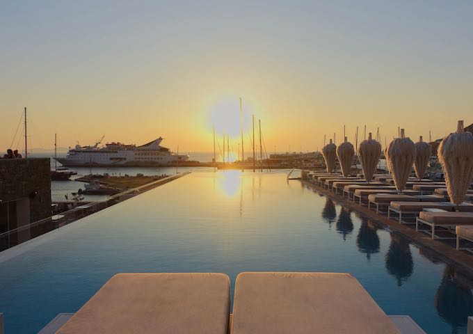 Pool and sunset view over the marina at Mykonos Riviera in Tourlos