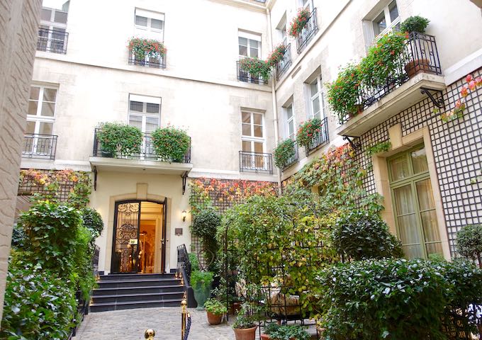The courtyard entrance of Relais Christine in Paris