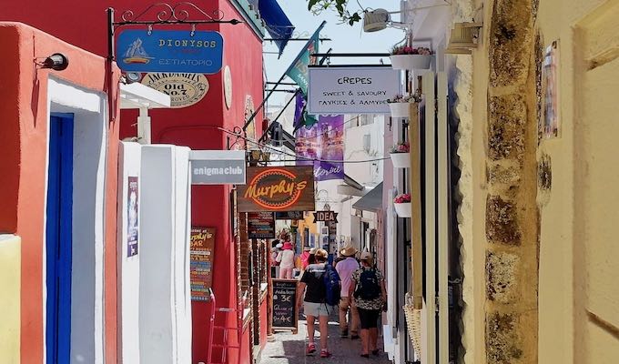 A narrow lane in Fira with bars, restaurants, and shops