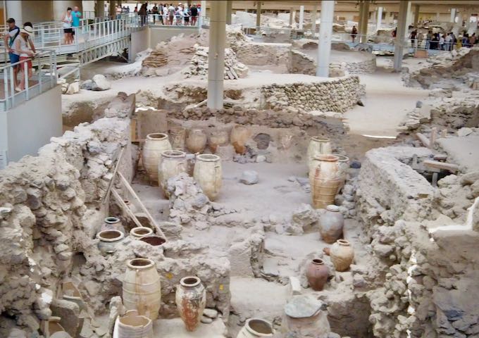 Tourists gather around to view an excavated ruins site
