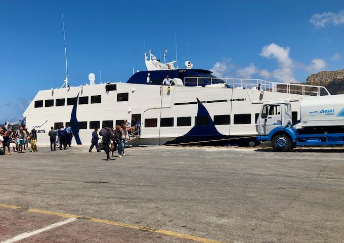 Passengers disembark a ferry in Greece