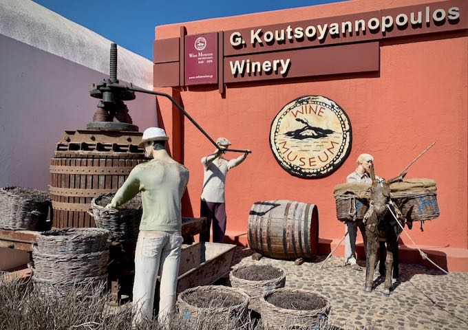 Sign and dioramas in front of a winery and wine museum in Santorini