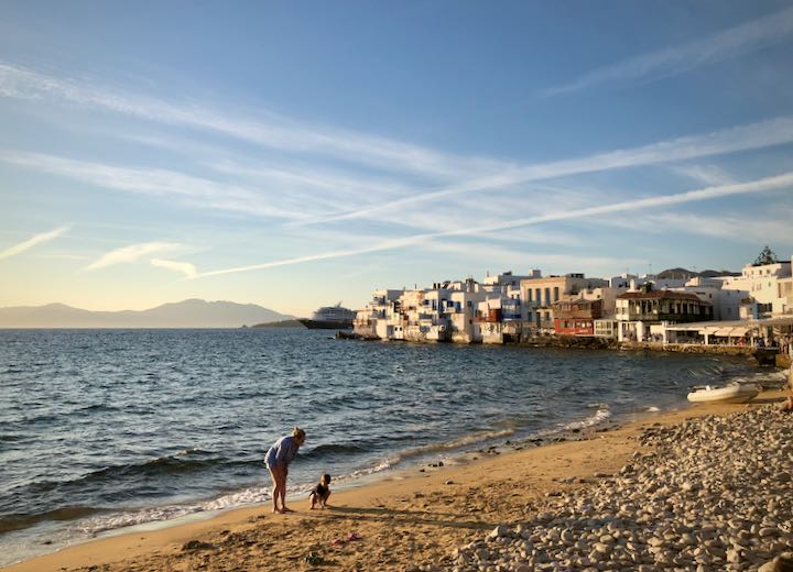 A woman and a child at sunset, exploring the beach at Mykonos Town