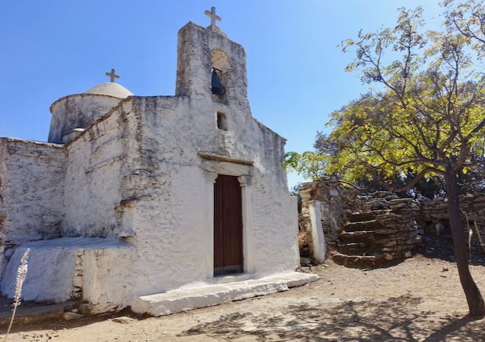 An old, whitewasged Byzantine church in Greece
