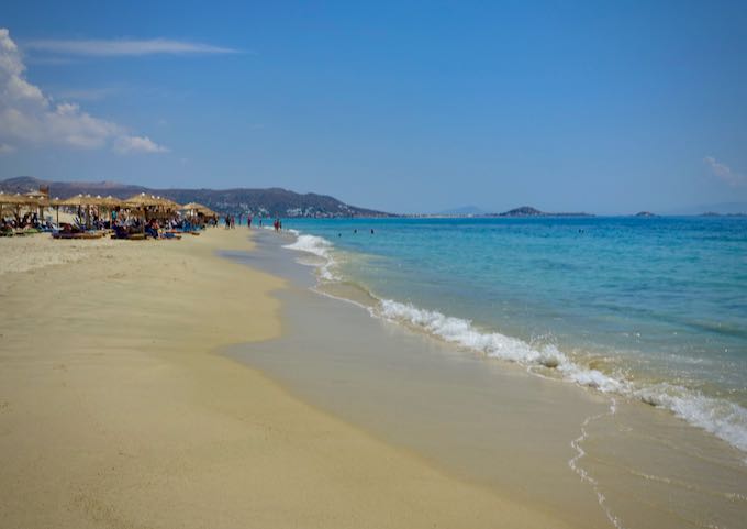Wide expanse of golden sand and turquoise water at Plaka Beach in Naxos