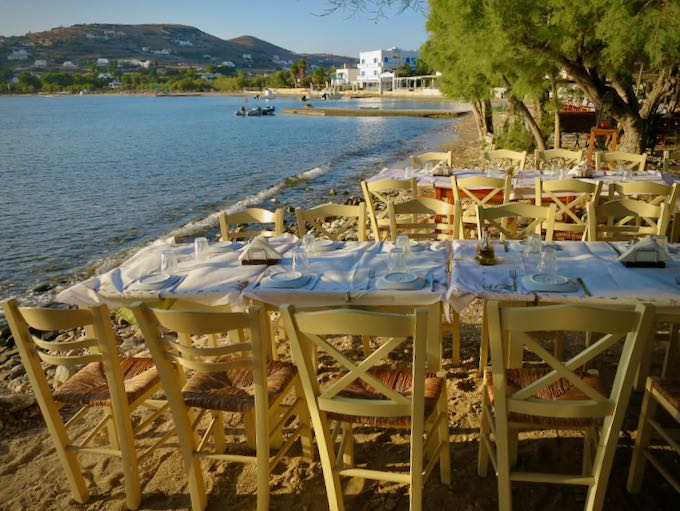 Table set for dinner on a sandy beach