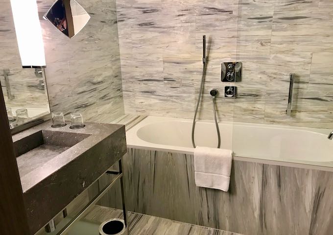 The marble bathrooms have bathtubs.