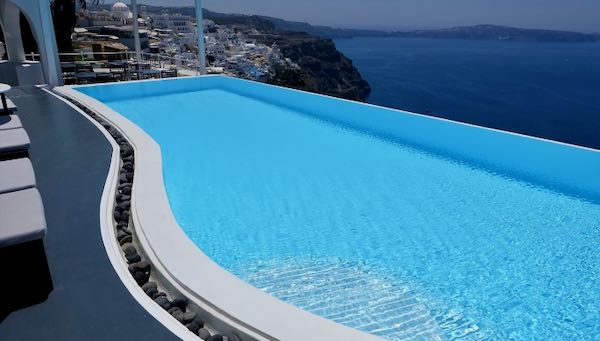 Hotel with infinity pool view of caldera in Santorini.
