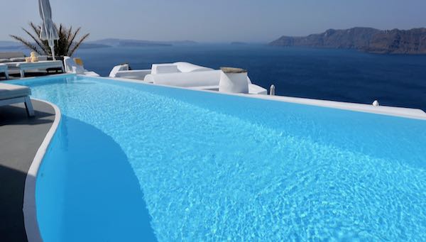 Hotel with infinity pool view of caldera in Santorini.