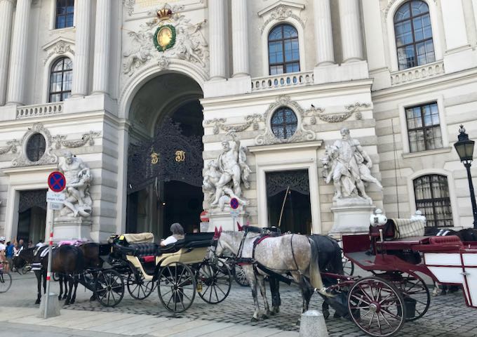 There are many horse carriages at Albertina Square.