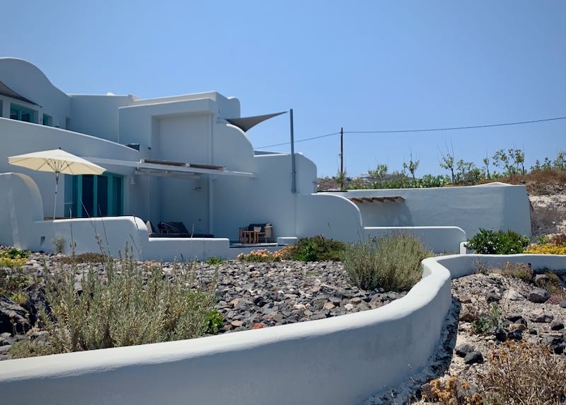 Terrace of a Cycycladic-style villa, with a garden and sun shade