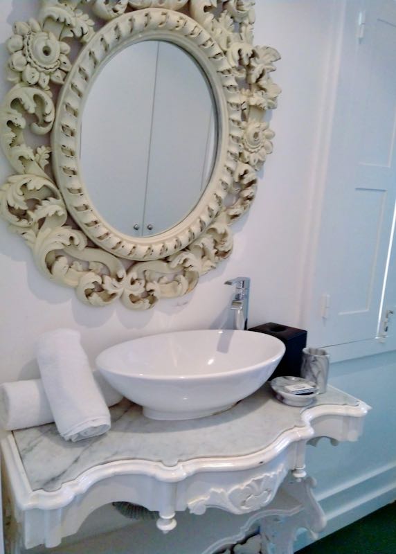 The bathroom has a beautiful mirror.