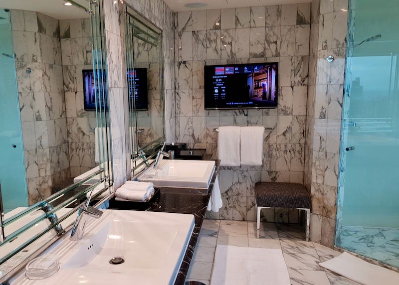 Suite bathrooms have dual vanities and TVs.