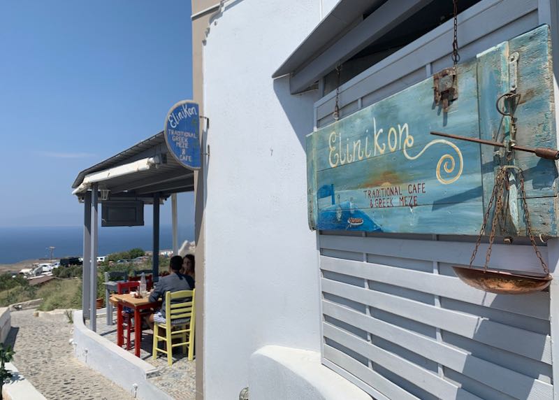 Sign at Rooftop patio with water view at Elinikon restaurant in Oia Santorini