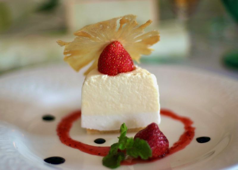 Semifreddo on a plate, garnished with berries, mint, and balsamic reduction