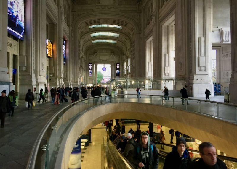 View of the entrance level, and looking down toward a lower level, of Milano Centrale station