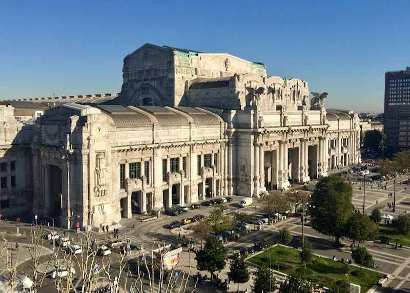 Exterior of Milano Centrale Train Station from a distance on a sunny day